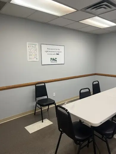 Bright meeting room with chairs and a table at PAC Program detox center in Bronx.
