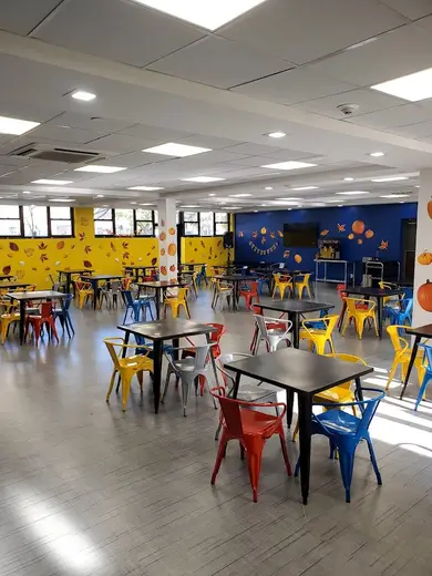 Brightly colored dining area with tables at Surfpoint Recovery, a detox center in Bronx.