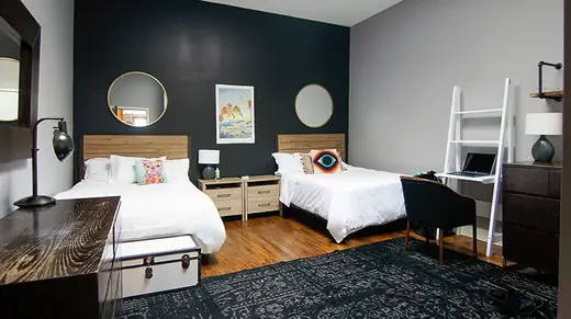 Cozy bedroom with two beds at Williamsburg House, a sober living home in Bronx.